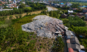 Garbage mound amidst rural landscape
